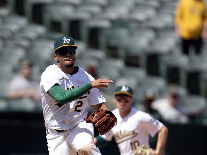 Apr 17, 2024; Oakland, California, USA; Oakland Athletics third baseman Darell Hernaiz (2) leaves his feet to throw out St. Louis Cardinals pinch hitter Jordan Walker at first base during the sixth inning at Oakland-Alameda County Coliseum. Mandatory Credit: D. Ross Cameron-USA TODAY Sports