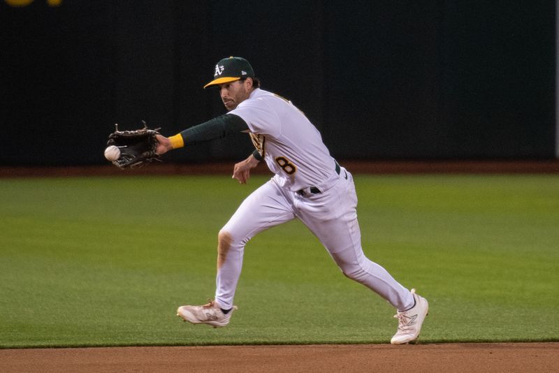 Jun 27, 2023; Oakland, California, USA; Oakland Athletics left fielder Tyler Wade (8) fields a ground ball during the ninth inning against the New York Yankees at Oakland-Alameda County Coliseum. Mandatory Credit: Ed Szczepanski-USA TODAY Sports