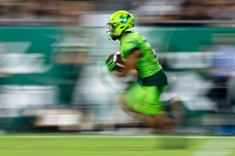 Nov 26, 2022; Tampa, Florida, USA; South Florida Bulls running back Brian Battie (21) runs with the ball against the UCF Knights during the third quarter at Raymond James Stadium. Mandatory Credit: Douglas DeFelice-USA TODAY Sports