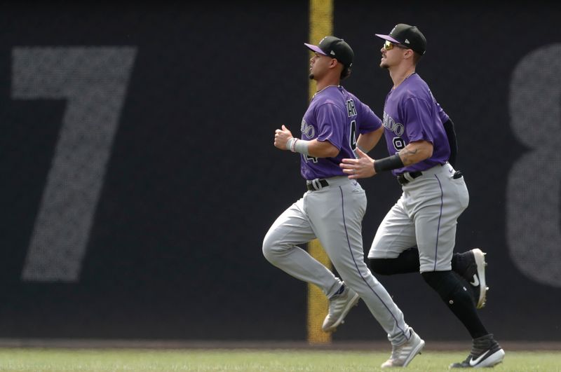 May 10, 2023; Pittsburgh, Pennsylvania, USA;  Colorado Rockies shortstop Ezequiel Tovar (14) and center fielder Brenton Doyle (9) warm up in the outfield before the game against the Pittsburgh Pirates at PNC Park. Mandatory Credit: Charles LeClaire-USA TODAY Sports