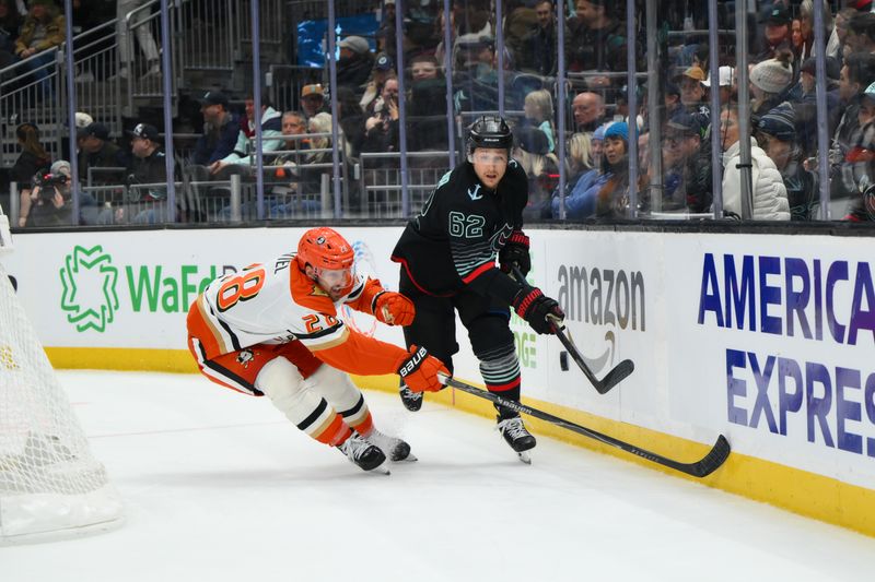 Jan 23, 2026; Seattle, Washington, USA; Seattle Kraken defenseman Brandon Montour (62) passes the puck away from Anaheim Ducks left wing Jeffrey Viel (28) during the third period at Climate Pledge Arena. Mandatory Credit: Steven Bisig-Imagn Images