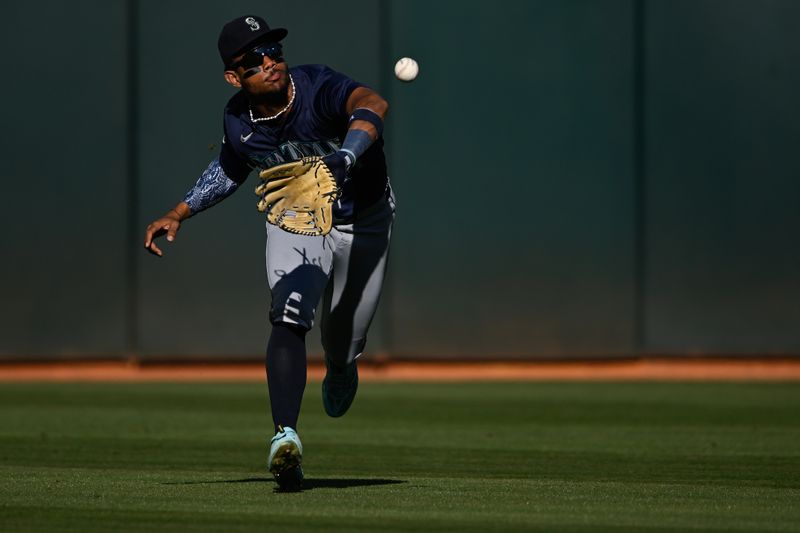 Sep 2, 2024; Oakland, California, USA; Seattle Mariners outfielder Julio Rodríguez (44) catches a fly ball hit by the Oakland Athletics in the fifth inning at Oakland-Alameda County Coliseum. Mandatory Credit: Eakin Howard-USA TODAY Sports