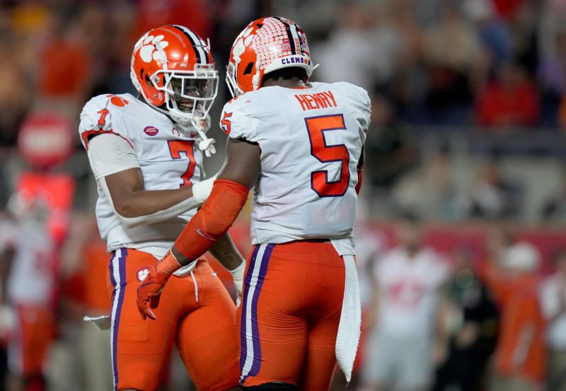 Dec 29, 2021; Orlando, Florida, USA; Clemson Tigers defensive end K.J. Henry (5) celebrates his sack of Iowa State Cyclones quarterback Brock Purdy (15) with Clemson Tigers defensive end Justin Mascoll (7) during the second half of the 2021 Cheez-It Bowl at Camping World Stadium. Mandatory Credit: Jasen Vinlove-USA TODAY Sports