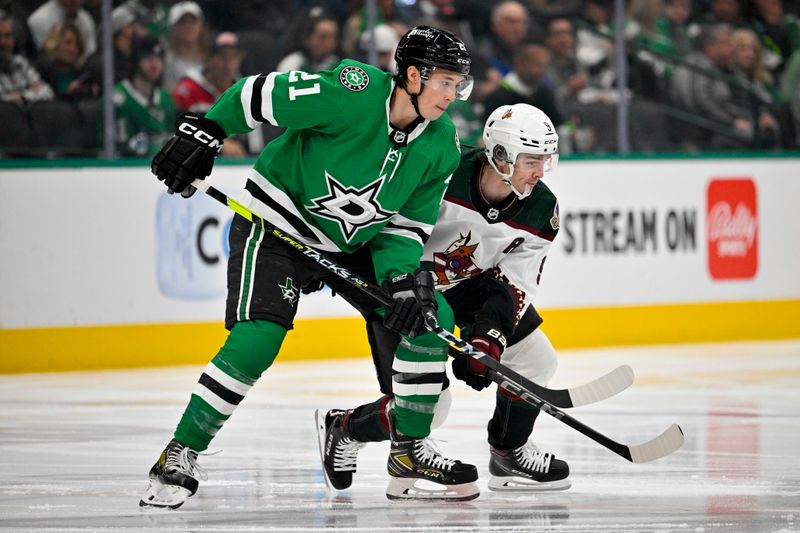 Mar 20, 2024; Dallas, Texas, USA; Dallas Stars left wing Jason Robertson (21) and Arizona Coyotes right wing Clayton Keller (9) look for the puck off the face-off during the first period at the American Airlines Center. Mandatory Credit: Jerome Miron-USA TODAY Sports