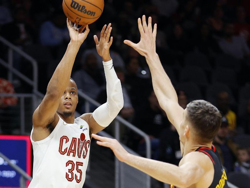 ATLANTA, GEORGIA - JANUARY 20: Isaac Okoro #35 of the Cleveland Cavaliers shoots over Bogdan Bogdanovic #13 of the Atlanta Hawks during the first half at State Farm Arena on January 20, 2024 in Atlanta, Georgia. NOTE TO USER: User expressly acknowledges and agrees that, by downloading and or using this photograph, User is consenting to the terms and conditions of the Getty Images License Agreement. (Photo by Alex Slitz/Getty Images)