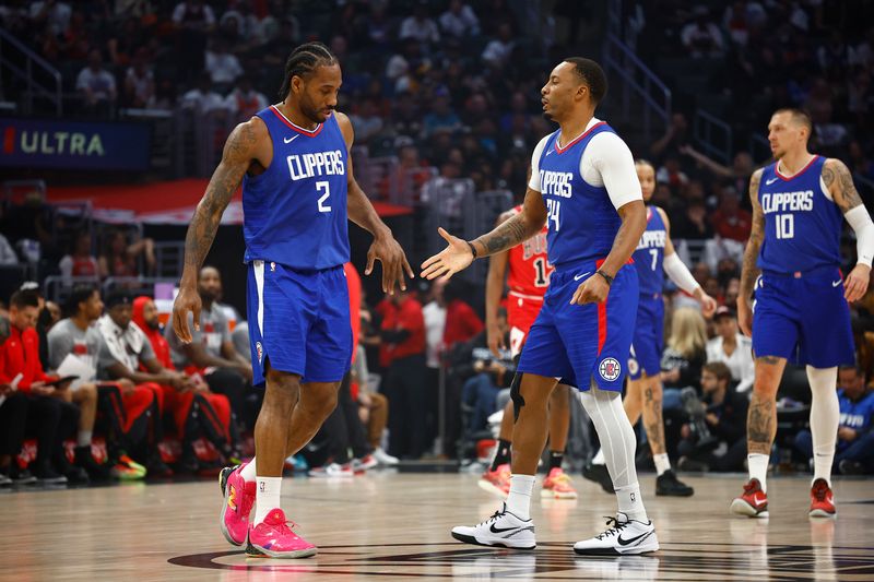 LOS ANGELES, CALIFORNIA - MARCH 09:  Kawhi Leonard #2 of the LA Clippers and Norman Powell #24 of the LA Clippers in the first half at Crypto.com Arena on March 09, 2024 in Los Angeles, California.  NOTE TO USER: User expressly acknowledges and agrees that, by downloading and/or using this photograph, user is consenting to the terms and conditions of the Getty Images License Agreement.  (Photo by Ronald Martinez/Getty Images)