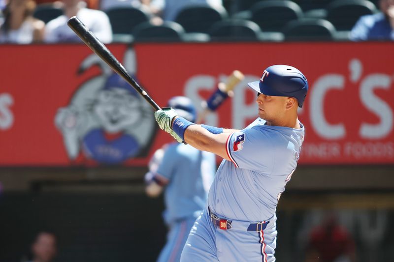 Sep 8, 2024; Arlington, Texas, USA; Texas Rangers first base Nathaniel Lowe (30) hits a two run home run against the Los Angeles Angels in the first inning at Globe Life Field. Mandatory Credit: Tim Heitman-Imagn Images