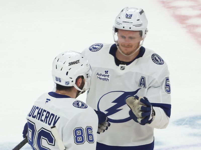 Jan 13, 2026; Pittsburgh, Pennsylvania, USA;  Tampa Bay Lightning center Jake Guentzel (59) congratulates right wing Nikita Kucherov (86) on his game winning shootout goal against the Pittsburgh Penguins at PPG Paints Arena. Mandatory Credit: Charles LeClaire-Imagn Images