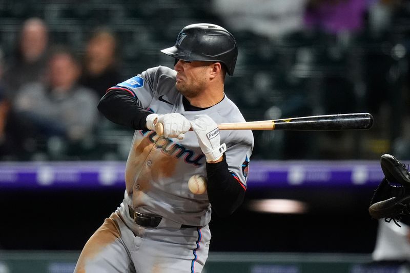 Sep 17, 2025; Denver, Colorado, USA; Miami Marlins center tfielder Jakob Marsee (87) is hit by a baseball in the sixth inning against the Colorado Rockies at Coors Field. Mandatory Credit: Ron Chenoy-Imagn Images