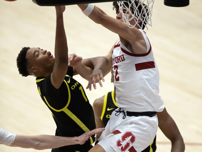 Feb 22, 2024; Stanford, California, USA; Stanford Cardinal guard Andrej Stojakovic (2) blocks a shot by Oregon Ducks forward Kwame Evans Jr. (10) during the second half at Maples Pavilion. Mandatory Credit: D. Ross Cameron-USA TODAY Sports