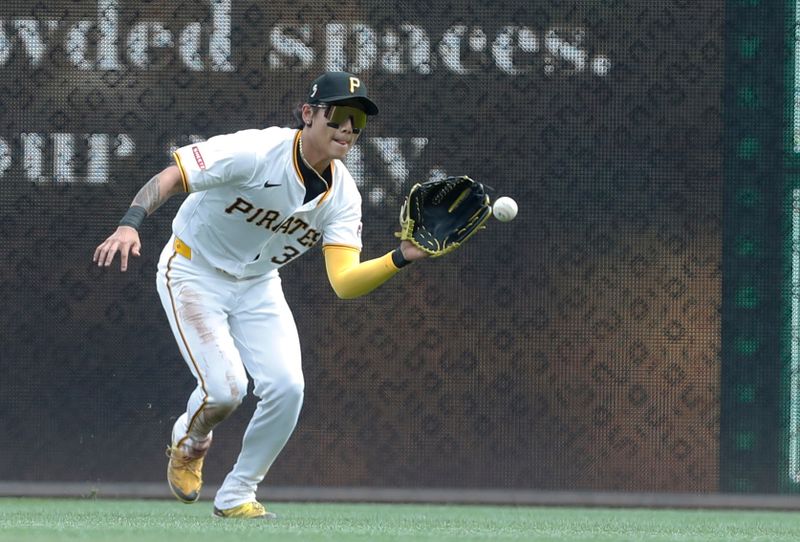 Aug 18, 2024; Pittsburgh, Pennsylvania, USA;  Pittsburgh Pirates right  fielder Ji Hwan Bae (3) fields a ball in the outfield against the Seattle Mariners during the seventh inning at PNC Park. Mandatory Credit: Charles LeClaire-USA TODAY Sports
