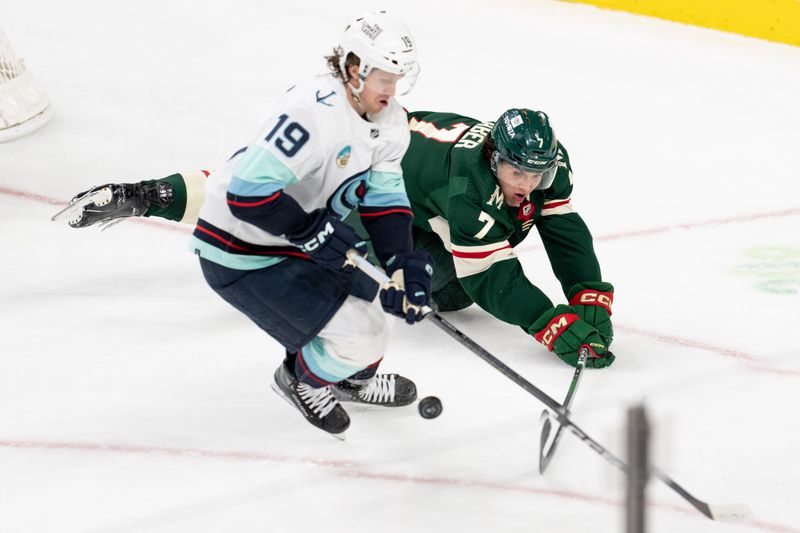 Apr 18, 2024; Saint Paul, Minnesota, USA; Minnesota Wild defenseman Brock Faber (7) knocks the puck aways from Seattle Kraken left wing Jared McCann (19) in the second period at Xcel Energy Center. Mandatory Credit: Matt Blewett-USA TODAY Sports