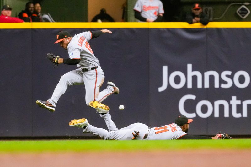 May 19, 2025; Milwaukee, Wisconsin, USA;  Baltimore Orioles center fielder Cedric Mullins (31) tries to make a diving catch on the fly ball hit by Milwaukee Brewers second baseman Brice Turang (2) (not pictured) during the fifth inning at American Family Field. Mandatory Credit: Jeff Hanisch-Imagn Images