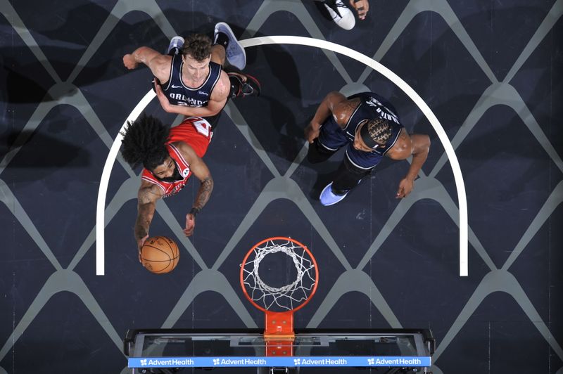 ORLANDO, FL - APRIL 7: Coby White #0 of the Chicago Bulls drives to the basket during the game against the Orlando Magic on April 7, 2024 at the Kia Center in Orlando, Florida. NOTE TO USER: User expressly acknowledges and agrees that, by downloading and or using this photograph, User is consenting to the terms and conditions of the Getty Images License Agreement. Mandatory Copyright Notice: Copyright 2024 NBAE (Photo by Fernando Medina/NBAE via Getty Images)