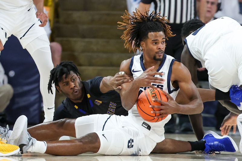 Jan 30, 2024; Logan, Utah, USA; San Jose State Spartans guard Latrell Davis (6) and Utah State Aggies guard Josh Uduje (14) play for a loose ball during the second half at Dee Glen Smith Spectrum. Mandatory Credit: Rob Gray-USA TODAY Sports