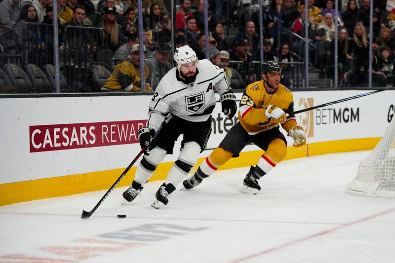 Dec 28, 2023; Las Vegas, Nevada, USA; Los Angeles Kings defenseman Drew Doughty (8) skates with the puck against Vegas Golden Knights defenseman Alec Martinez (23) during the third period at T-Mobile Arena. Mandatory Credit: Lucas Peltier-USA TODAY Sports