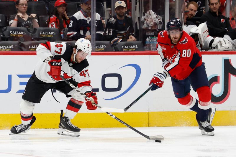 Oct 12, 2024; Washington, District of Columbia, USA; New Jersey Devils center Paul Cotter (47) and Washington Capitals left wing Pierre-Luc Dubois (80) battle for the puck in the third period at Capital One Arena. Mandatory Credit: Geoff Burke-Imagn Images