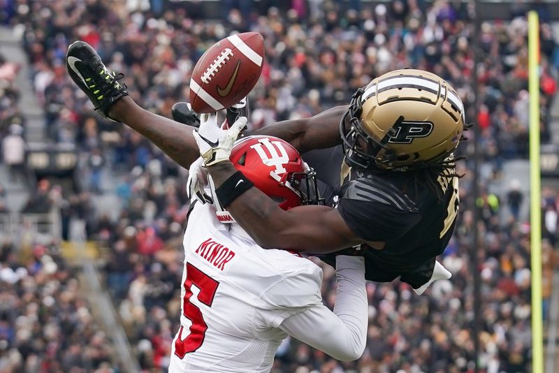 Nov 25, 2023; West Lafayette, Indiana, USA; Indiana Hoosiers defensive back Kobee Minor (5) commits a pass interference penalty against Purdue Boilermakers wide receiver Deion Burks (4) during the second half at Ross-Ade Stadium. Mandatory Credit: Robert Goddin-USA TODAY Sports