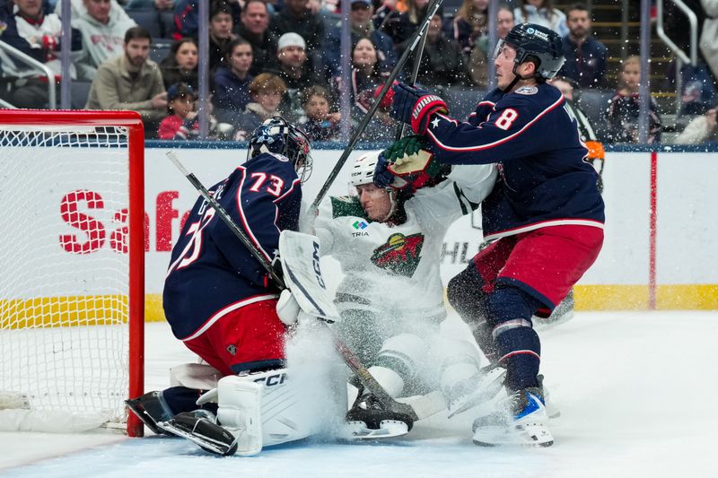 Dec 18, 2025; Columbus, Ohio, USA;  Columbus Blue Jackets goaltender Jet Greaves (73) defends the net as Minnesota Wild center Ben Jones (39) is hit by Columbus Blue Jackets defenseman Zach Werenski (8) in the second period at Nationwide Arena. Mandatory Credit: Aaron Doster-Imagn Images