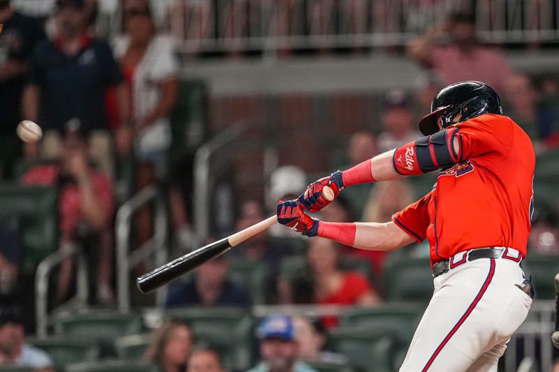 Aug 2, 2024; Cumberland, Georgia, USA; Atlanta Braves third baseman Austin Riley (27) hits a double against the Miami Marlins during the eighth inning at Truist Park. Mandatory Credit: Dale Zanine-USA TODAY Sports