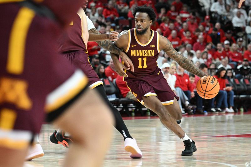 Mar 1, 2025; Lincoln, Nebraska, USA; Minnesota Golden Gophers guard Femi Odukale (11) dribbles against the Nebraska Cornhuskers during the second half at Pinnacle Bank Arena. Mandatory Credit: Steven Branscombe-Imagn Images