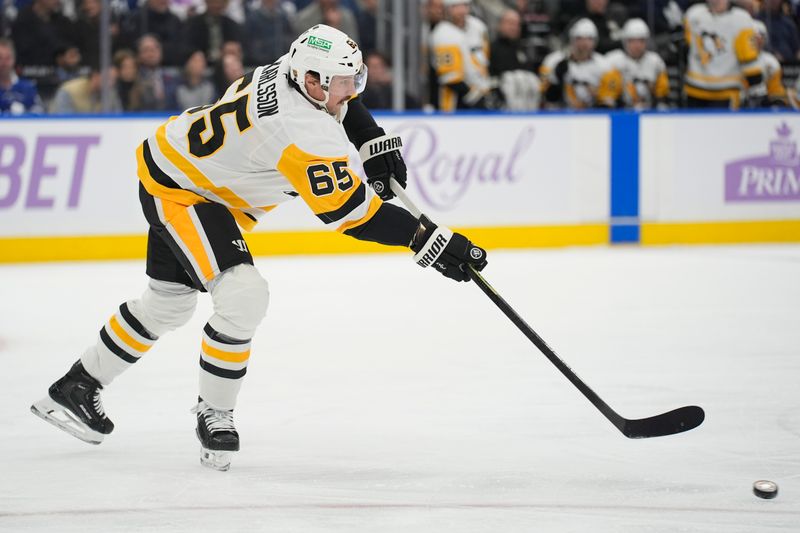 Nov 3, 2025; Toronto, Ontario, CAN; Pittsburgh Penguins defenseman Erik Karlsson (65) shoots against the Toronto Maple Leafs during the first period at Scotiabank Arena. Mandatory Credit: John E. Sokolowski-Imagn Images