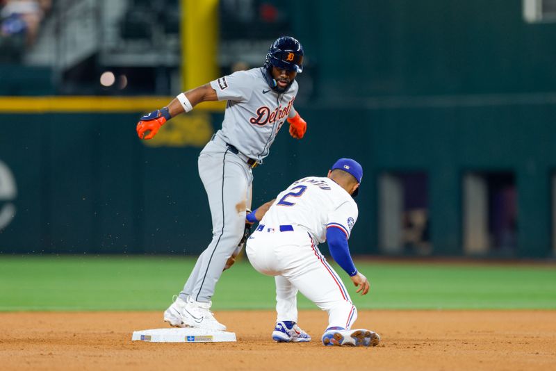 Jun 4, 2024; Arlington, Texas, USA; Detroit Tigers outfielder Akil Baddoo (60) slides in under the tag by Texas Rangers second base Marcus Semien (2) during the second inning at Globe Life Field. Mandatory Credit: Andrew Dieb-USA TODAY Sports