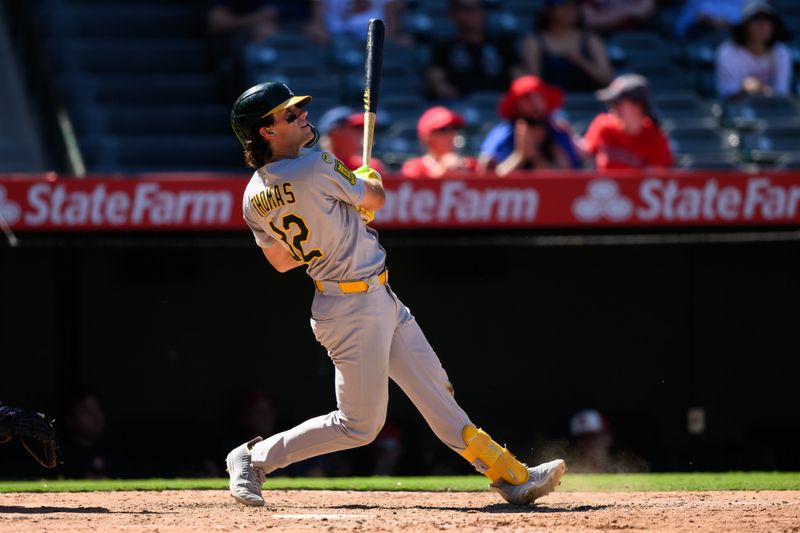 Sep 7, 2025; Anaheim, California, USA; Athletics right fielder Colby Thomas (32) hits a sacrifice fly to tie the game against the Los Angeles Angels during the eighth inning at Angel Stadium. Mandatory Credit: William Liang-Imagn Images