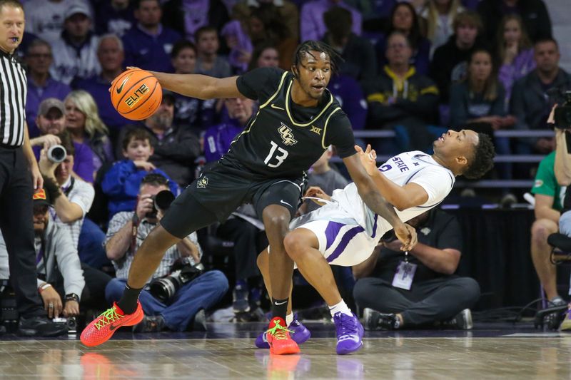 Jan 6, 2024; Manhattan, Kansas, USA; UCF Knights forward Marchelus Avery (13) fouls Kansas State Wildcats guard Tylor Perry (2) during the first half at Bramlage Coliseum. Mandatory Credit: Scott Sewell-USA TODAY Sports