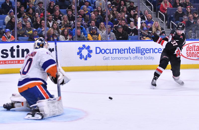 Oct 21, 2023; Buffalo, New York, USA; Buffalo Sabres center Casey Mittelstadt (37) shoots the puck as New York Islanders goaltender Semyon Varlamov (40) defends in the second period  at KeyBank Center. Mandatory Credit: Mark Konezny-USA TODAY Sports