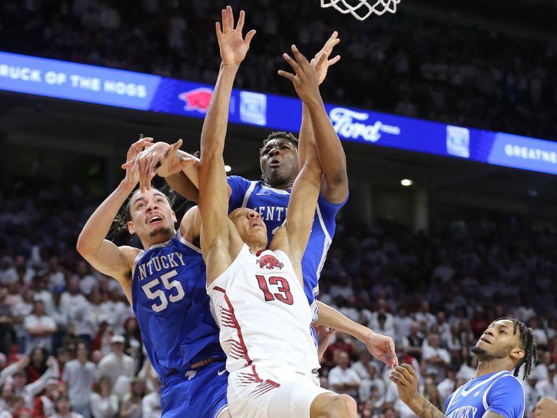 Mar 4, 2023; Fayetteville, Arkansas, USA; Kentucky Wildcats forward Lance Ware (55) and Arkansas Razorbacks guard Jordan Walsh (13) reach for a loose ball in the first half at Bud Walton Arena. Mandatory Credit: Nelson Chenault-USA TODAY Sports