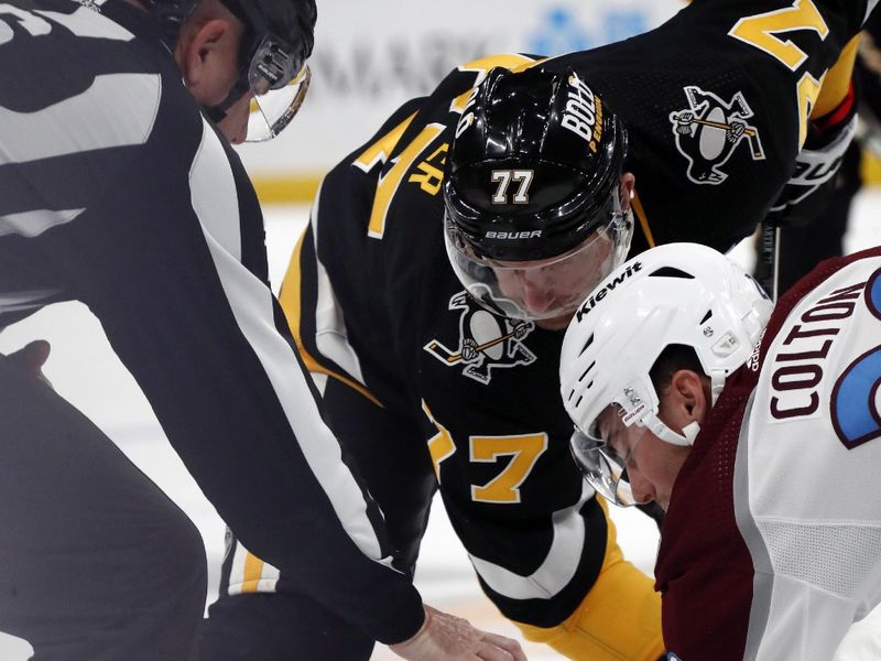 Oct 26, 2023; Pittsburgh, Pennsylvania, USA; Pittsburgh Penguins center Jeff Carter (77) and Pittsburgh Penguins center Lars Eller (20) take a face-off during the third period  at PPG Paints Arena. The Penguins shutout the Avalanche 4-0. Mandatory Credit: Charles LeClaire-USA TODAY Sports