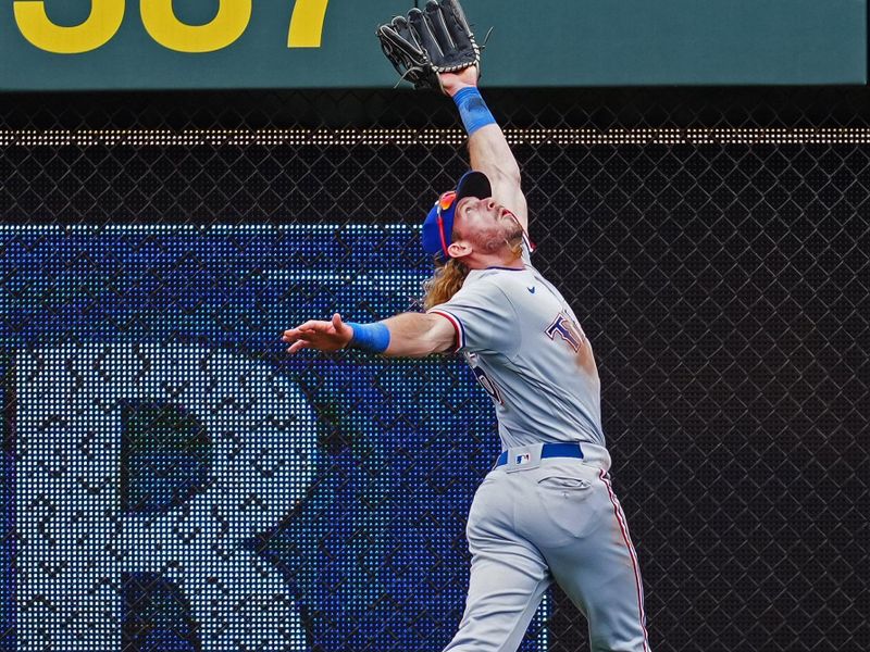 Apr 19, 2023; Kansas City, Missouri, USA; Texas Rangers left fielder Travis Jankowski (16) catches a fly ball at the wall during the first inning against the Kansas City Royals at Kauffman Stadium. Mandatory Credit: Jay Biggerstaff-USA TODAY Sports