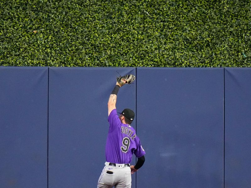 Jul 23, 2023; Miami, Florida, USA; Colorado Rockies center fielder Brenton Doyle (9) catches a fly ball against the Miami Marlins during the fifth inning at loanDepot Park. Mandatory Credit: Rich Storry-USA TODAY Sports