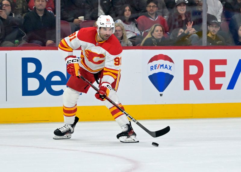 Nov 5, 2024; Montreal, Quebec, CAN; Calgary Flames forward Nazem Kadri (91) plays the puck during the first period of the game against the Montreal Canadiens at the Bell Centre. Mandatory Credit: Eric Bolte-Imagn Images