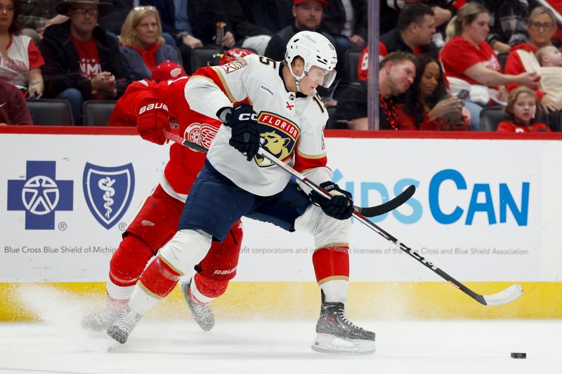 Mar 2, 2024; Detroit, Michigan, USA; Florida Panthers center Anton Lundell (15) skates with the puck defended by Detroit Red Wings defenseman Shayne Gostisbehere (41) in the third period at Little Caesars Arena. Mandatory Credit: Rick Osentoski-USA TODAY Sports