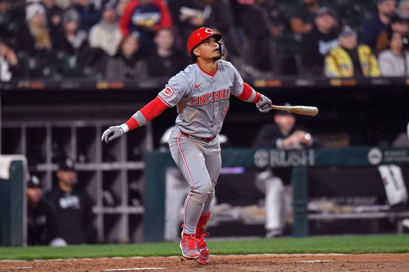 Apr 12, 2024; Chicago, Illinois, USA; Cincinnati Reds third base Santiago Espinal (4) hits a sacrifice RBI during the sixth inning against the Chicago White Sox at Guaranteed Rate Field. Mandatory Credit: Patrick Gorski-USA TODAY Sports