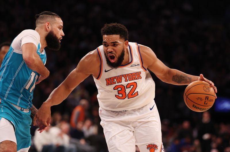 NEW YORK, NEW YORK - DECEMBER 05:  Karl-Anthony Towns #32 of the New York Knicks drives against Cody Martin #11 of the Charlotte Hornets during their game at Madison Square Garden on December 05, 2024 in New York City.  User expressly acknowledges and agrees that, by downloading and or using this photograph, User is consenting to the terms and conditions of the Getty Images License Agreement.  (Photo by Al Bello/Getty Images)