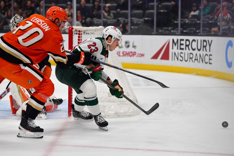 Dec 6, 2024; Anaheim, California, USA; Minnesota Wild center Marco Rossi (23) plays for the puck against Anaheim Ducks right wing Brett Leason (20) during the first period at Honda Center. Mandatory Credit: Gary A. Vasquez-Imagn Images