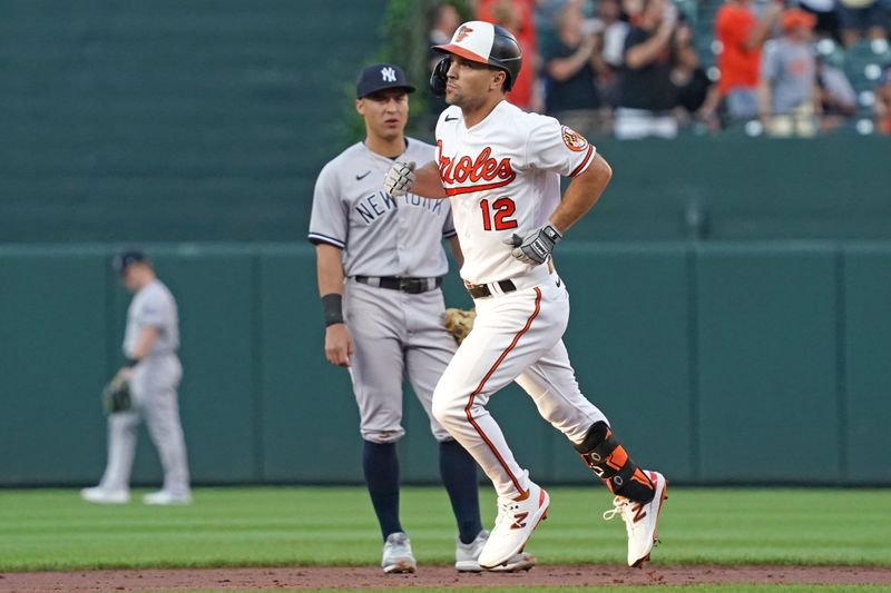 Jul 30, 2023; Baltimore, Maryland, USA; Baltimore Orioles outfielder Adam Frazier (12) rounds the bases following his three-run home run in the first inning against the New York Yankees at Oriole Park at Camden Yards. Mandatory Credit: Mitch Stringer-USA TODAY Sports