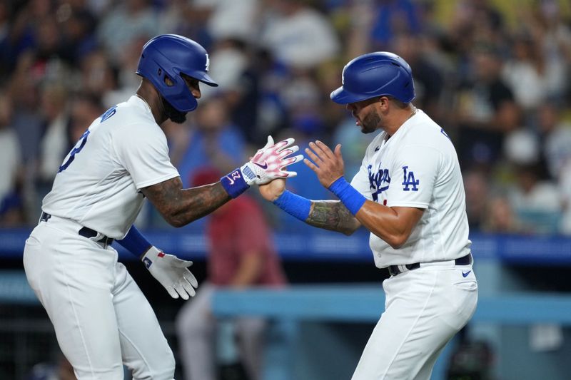 Aug 29, 2023; Los Angeles, California, USA; Los Angeles Dodgers right fielder Jason Heyward (23) celebrates with designated hitter David Peralta (6) after hitting a two-run home run in the third inning against the Arizona Diamondbacks at Dodger Stadium. Mandatory Credit: Kirby Lee-USA TODAY Sports