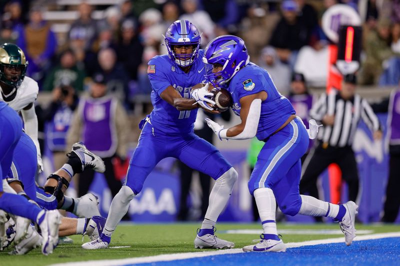 Oct 19, 2024; Colorado Springs, Colorado, USA; Air Force Falcons quarterback Josh Johnson (11) hands the ball off to fullback Terrence Gist (12) in the first quarter against the Colorado State Rams at Falcon Stadium. Mandatory Credit: Isaiah J. Downing-Imagn Images
