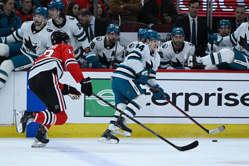 Jan 16, 2024; Chicago, Illinois, USA; San Jose Sharks left wing Alexander Barabanov (94) moves the puck against Chicago Blackhawks left wing Zach Sanford (13) during the first period at United Center. Mandatory Credit: Matt Marton-USA TODAY Sports