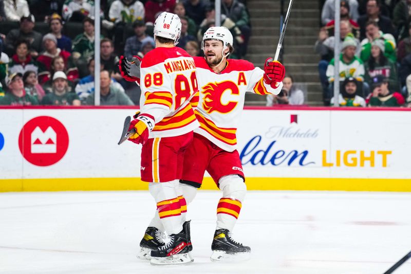 Jan 2, 2024; Saint Paul, Minnesota, USA; Calgary Flames left wing Andrew Mangiapane (88) celebrates his goal with Rasmus Andersson (4) during the first period against the Minnesota Wild at Xcel Energy Center. Mandatory Credit: Brace Hemmelgarn-USA TODAY Sports