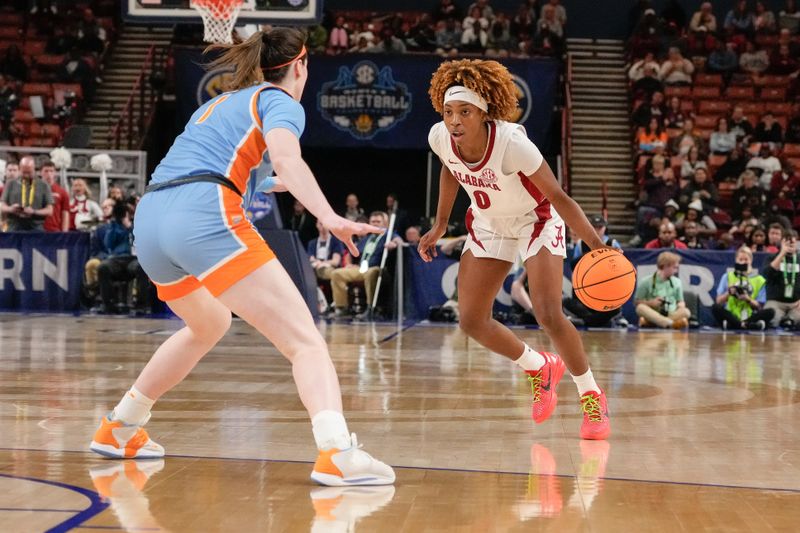 Mar 8, 2024; Greensville, SC, USA; Alabama Crimson Tide guard Loyal McQueen (0) handles the ball against Tennessee Lady Vols guard Sara Puckett (1) during the first half at Bon Secours Wellness Arena. Mandatory Credit: Jim Dedmon-USA TODAY Sports