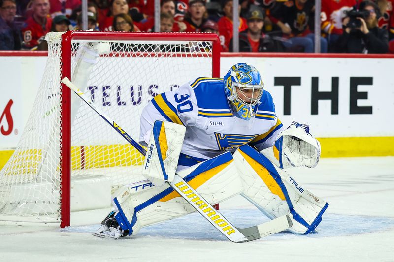 Oct 11, 2025; Calgary, Alberta, CAN; St. Louis Blues goaltender Joel Hofer (30) guards his net against the Calgary Flames during the second period at Scotiabank Saddledome. Mandatory Credit: Sergei Belski-Imagn Images