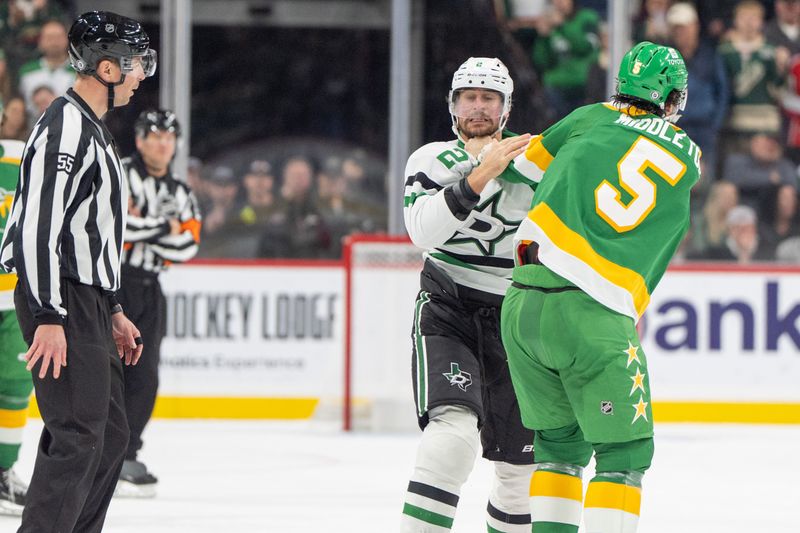 Nov 16, 2024; Saint Paul, Minnesota, USA; Dallas Stars defenseman Brendan Smith (2) and Minnesota Wild defenseman Jake Middleton (5) fight in the first period at Xcel Energy Center. Mandatory Credit: Matt Blewett-Imagn Images