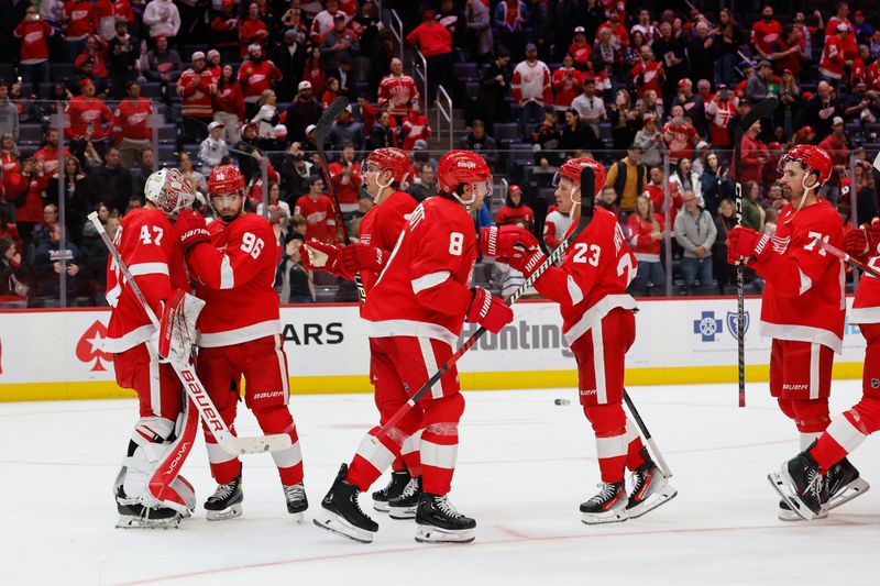 Oct 22, 2023; Detroit, Michigan, USA;  Detroit Red Wings celebrate after defeating the Calgary Flames at Little Caesars Arena. Mandatory Credit: Rick Osentoski-USA TODAY Sports