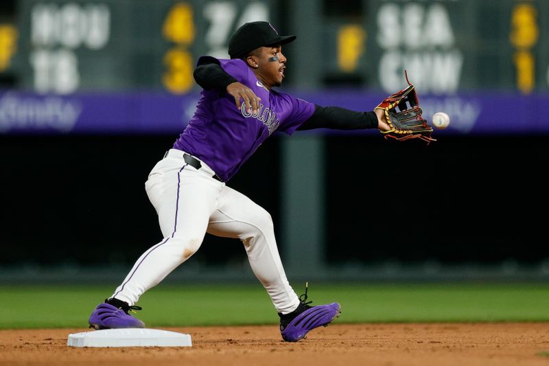 May 19, 2025; Denver, Colorado, USA; Colorado Rockies second baseman Adael Amador (1) is unable to field a throw at second in the seventh inning against the Philadelphia Phillies at Coors Field. Mandatory Credit: Isaiah J. Downing-Imagn Images