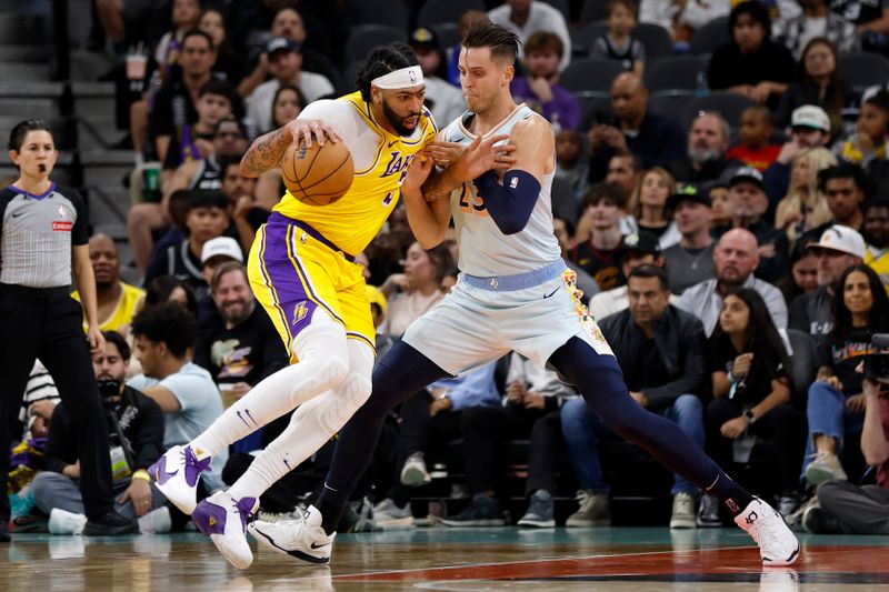 SAN ANTONIO, TEXAS - NOVEMBER 27: Anthony Davis #3 of the Los Angeles Lakers makes a move on Zach Collins #23 of the San Antonio Spurs during the first quarter at Frost Bank Center on November 27, 2024 in San Antonio, Texas. NOTE TO USER: User expressly acknowledges and agrees that, by downloading and or using this photograph, User is consenting to the terms and conditions of the Getty Images License Agreement (Photo by Ronald Cortes/Getty Images)